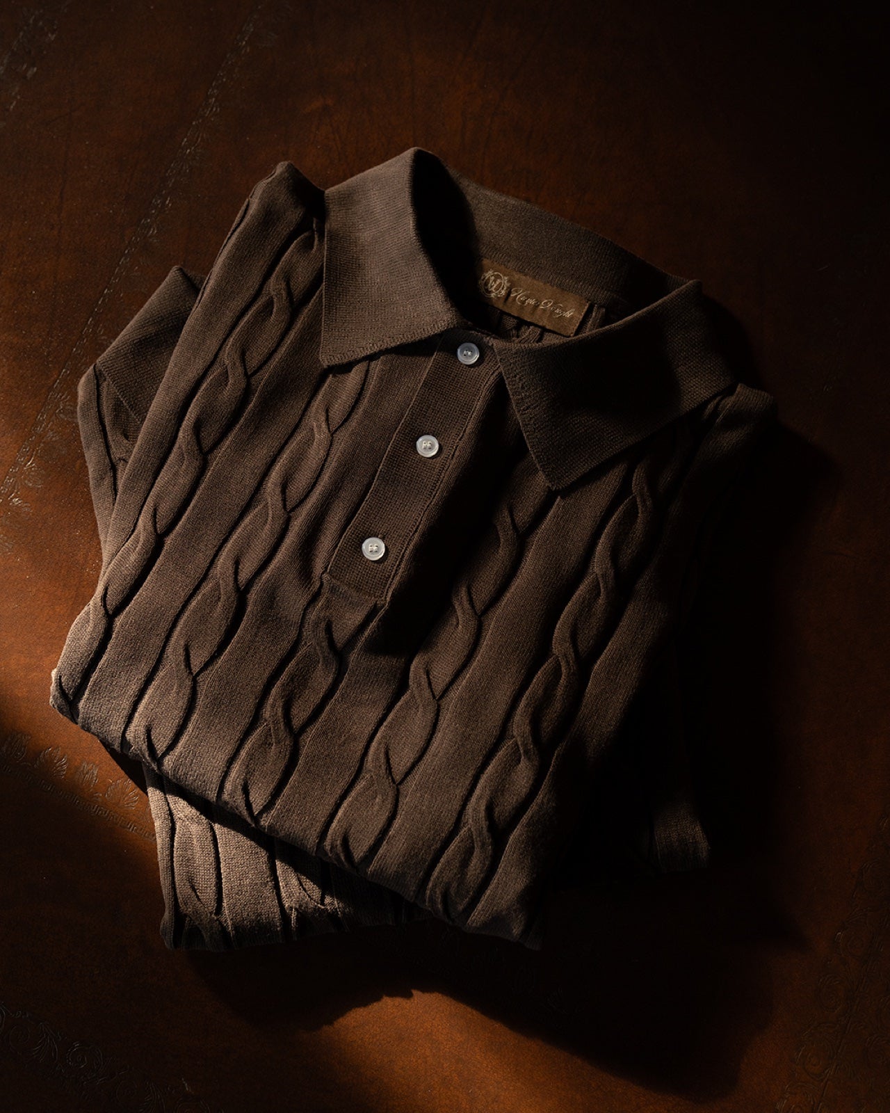 Hunter Vought cable-knit polo, folded editorial